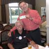 Bill Durmer gleefully accepts a $100 wager from Ed Cluck.  They had bet this on the Rutgers vs Arkansas game.  The $100 was generously donated to the GCAC Scholaship Fund.