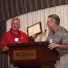 President John McCormick presents a plaque to past President, Fred Dickinson.