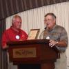 President John McCormick presents a plaque to past President, Fred Dickinson.